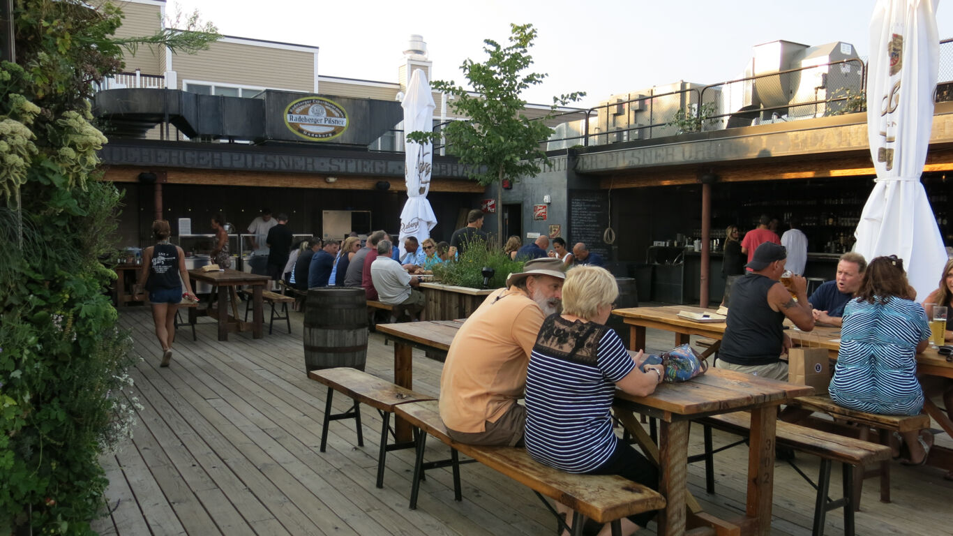 Angled view of customers enjoying drinks at Asbury Biergarten